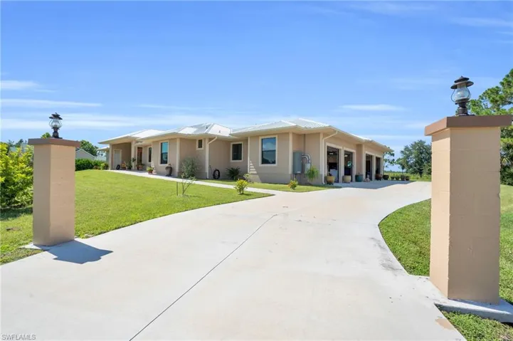 View of front of house featuring a garage and a front yard