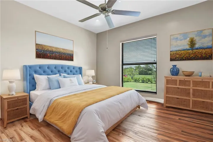 Bathroom featuring vanity, toilet, ceiling fan, and hardwood / wood-style floors