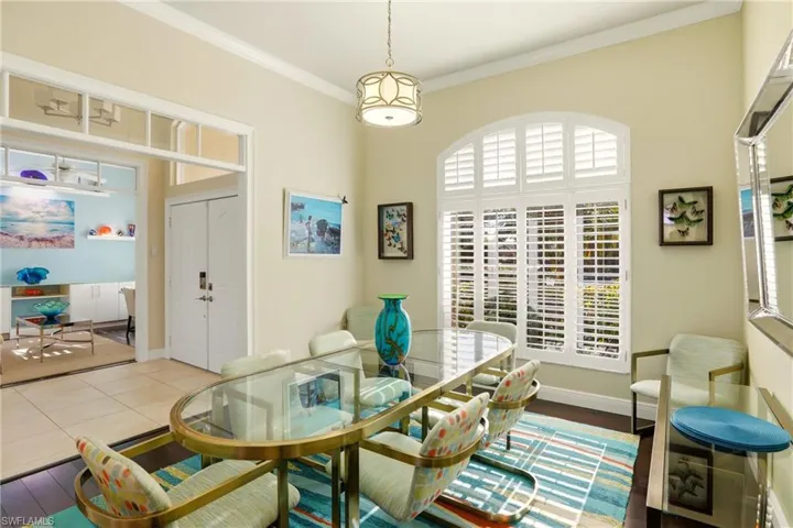 Dining area with ornamental molding and baseboards