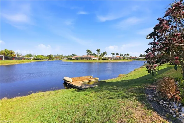 Dock area featuring a yard, a water view, and a residential view