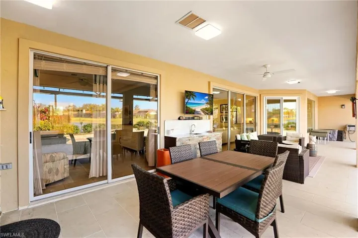 Dining area with ceiling fan and light tile patterned flooring