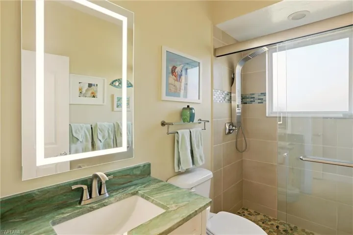 Full bathroom featuring vanity and a stall shower