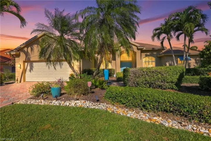Mediterranean / spanish-style house featuring stucco siding, an attached garage, and driveway