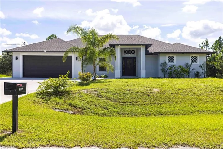 View of front facade featuring an attached garage, stucco siding, a shingled roof, and a front lawn