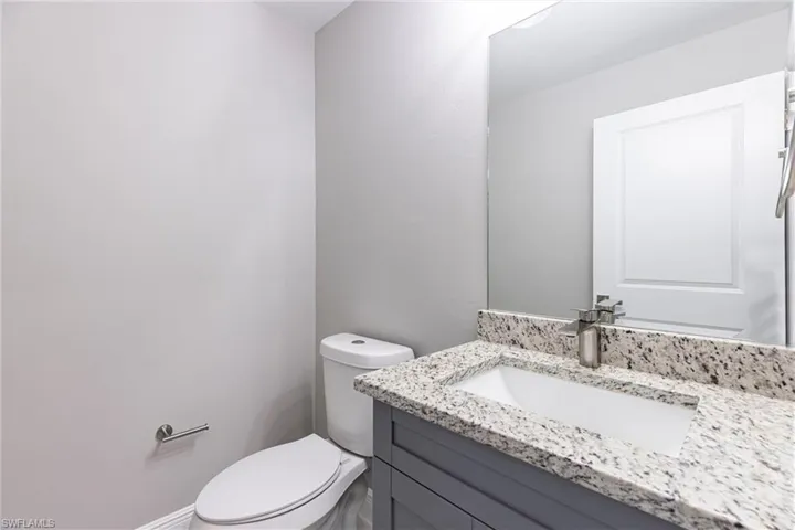 Half bath featuring vanity and toilet