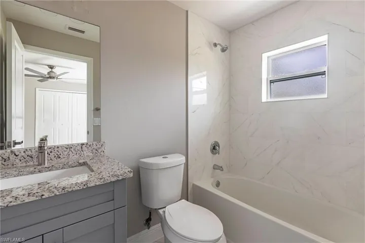 Full bath featuring tub / shower combination and vanity
