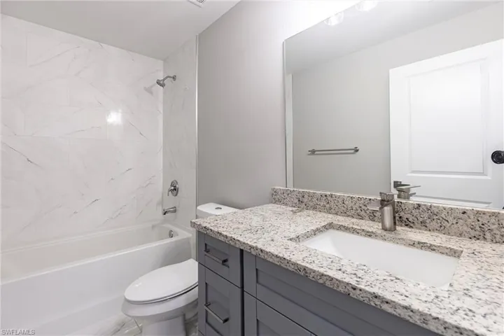 Full bath featuring vanity and  shower combination