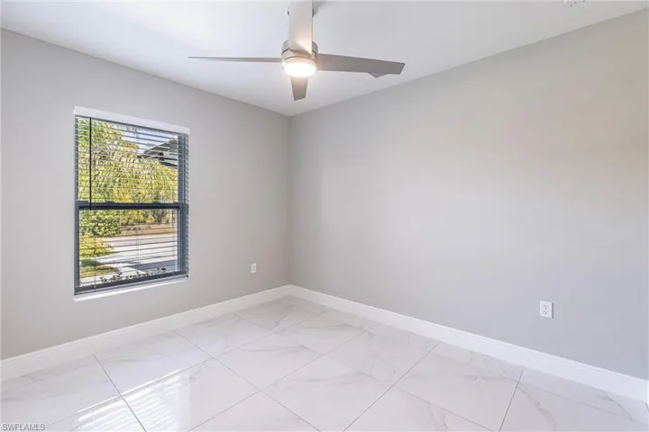 Empty room with light marble finish flooring and baseboards