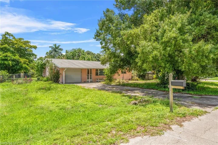 View of front of house with driveway and a garage