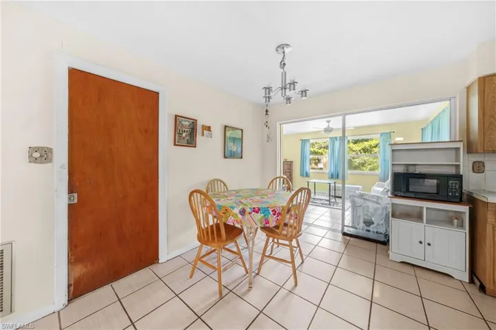 Dining space featuring light tile patterned floors and ceiling fan