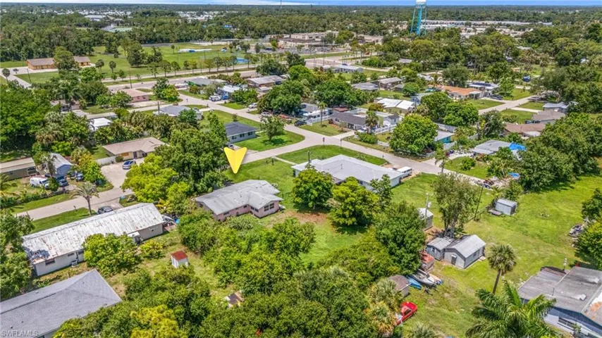 Aerial view of residential area featuring a tree filled landscape