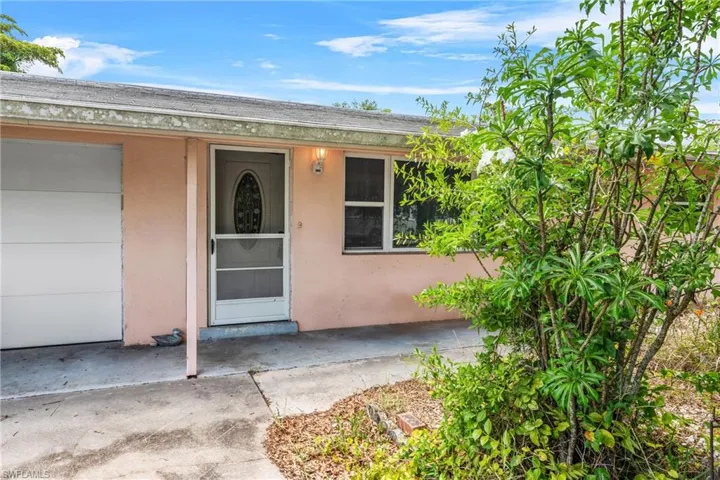 Doorway to property with stucco siding