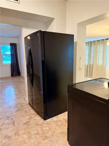 Kitchen with black appliances and dark brown cabinetry