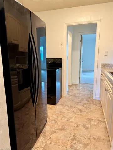 Kitchen with black appliances and light countertops