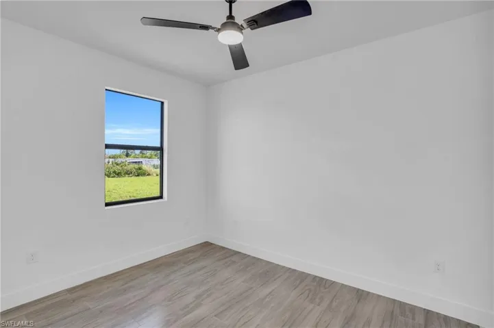 Unfurnished room featuring light hardwood / wood-style floors and ceiling fan