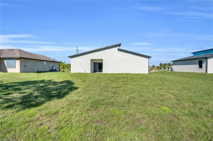 Back of property with a yard
