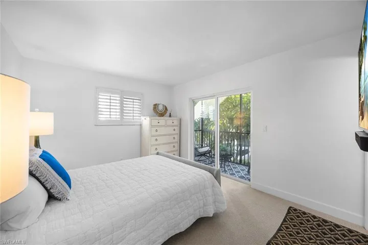 Bedroom featuring carpet flooring and access to exterior