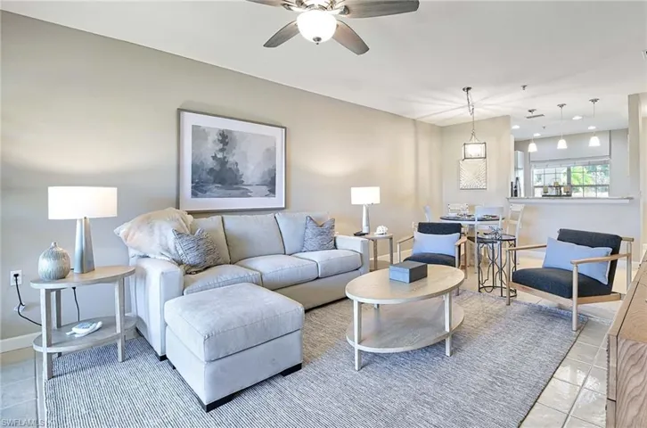 Living room with light tile patterned flooring and a ceiling fan