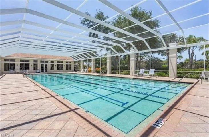 Community pool featuring a patio and glass enclosure