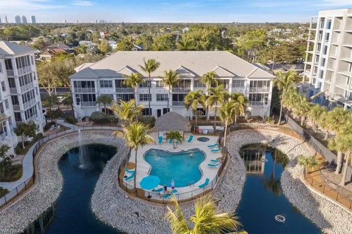 Community pool featuring a water view, a patio area, and a city view