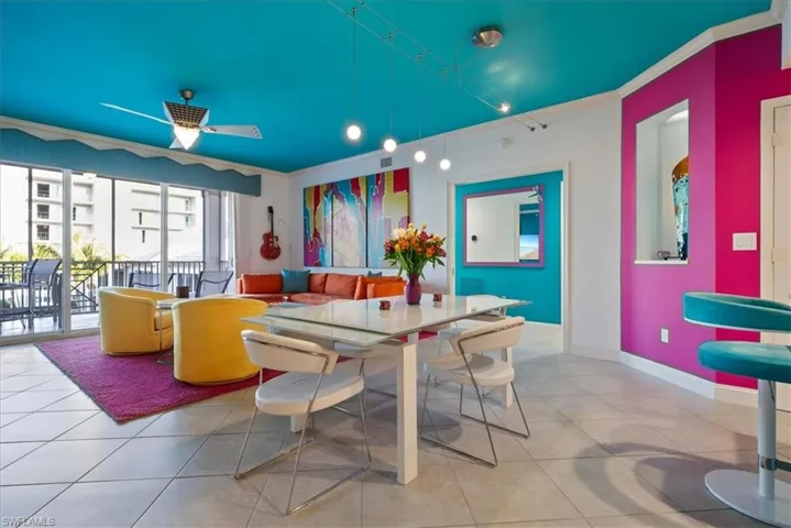 Dining space featuring crown molding, a ceiling fan, and tile patterned flooring