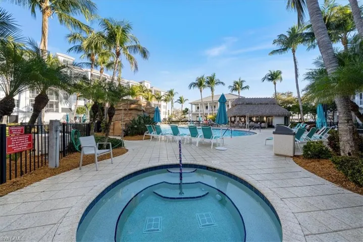 Community pool featuring a patio area and a hot tub