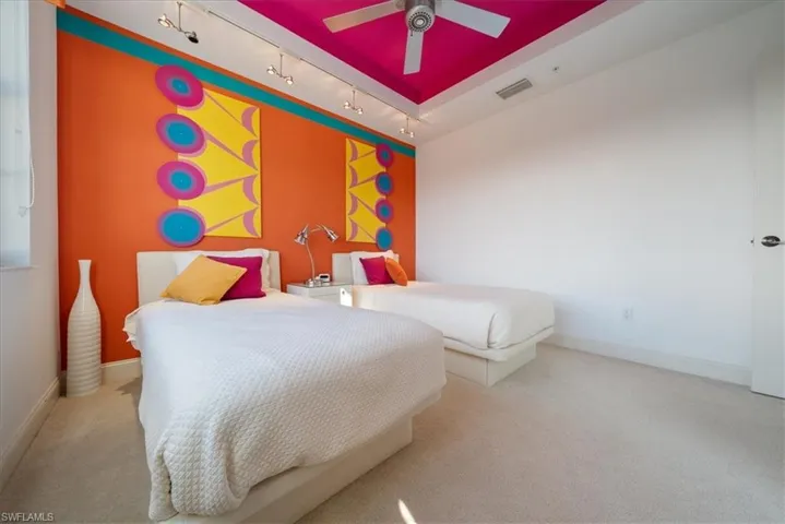 Bedroom featuring track lighting, carpet floors, and ceiling fan