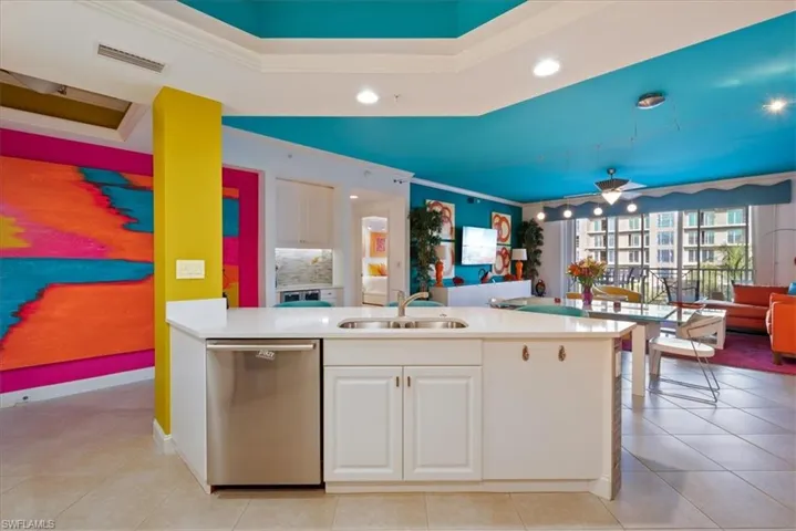 Kitchen with open floor plan, white cabinetry, stainless steel dishwasher, ornamental molding, and recessed lighting