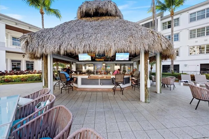 View of patio with an outdoor lounge area with bar and a gazebo