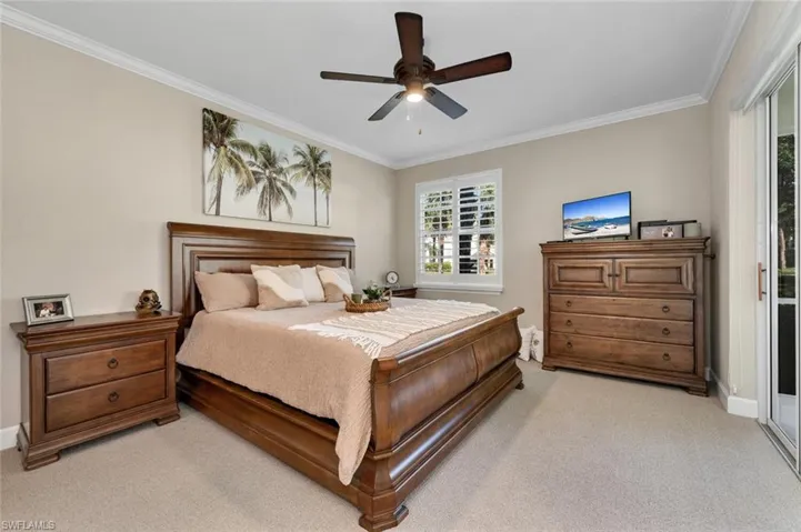 Primary Bedroom featuring ceiling fan, crown molding, light carpet, and access to Lanai