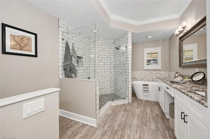 Primary Bathroom with walk-in shower, dual sinks, and soaking tub.