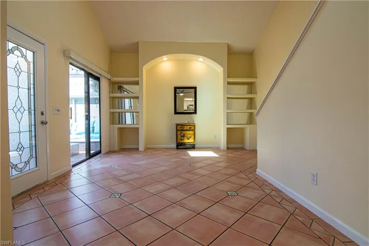 Lots of natural light provided by the high vaulted ceiling with a large skylight, custom glass front door and sliding doors leading to the courtyard!