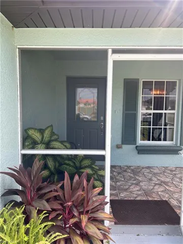 View of exterior entry featuring covered porch