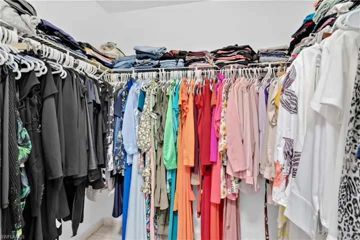 Walk in closet with light tile patterned flooring