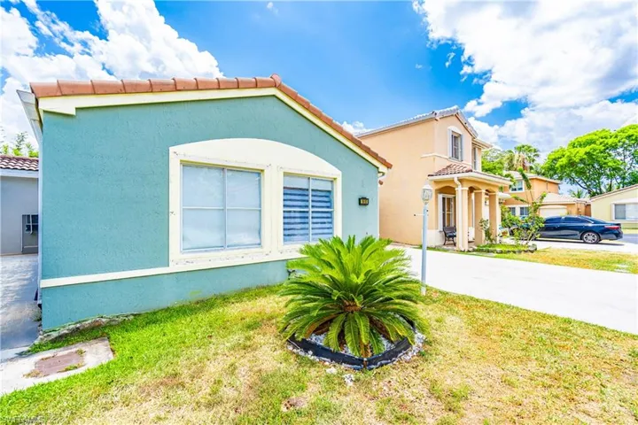 Mediterranean / spanish home with a front yard and a garage