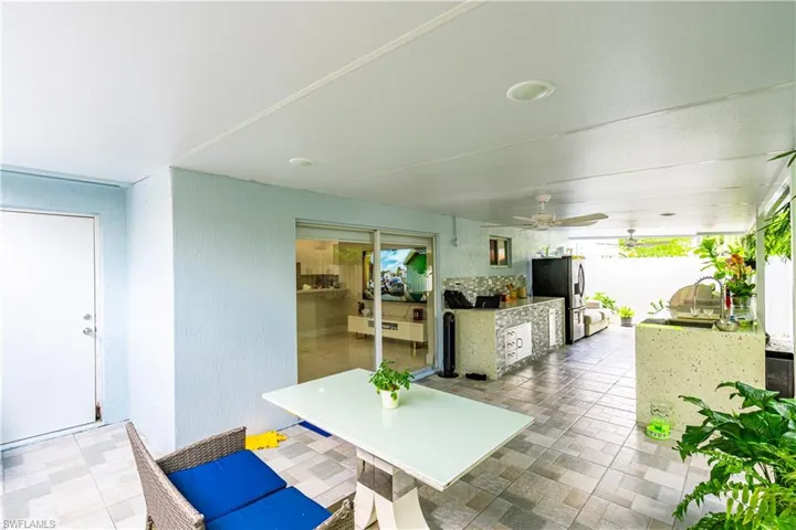 Tiled dining area with ceiling fan and sink