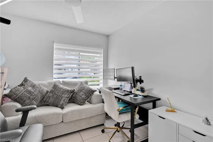 Office space featuring light tile patterned floors and a textured ceiling