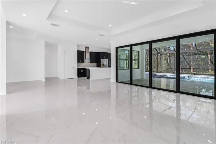 Tiled spare room with a tray ceiling