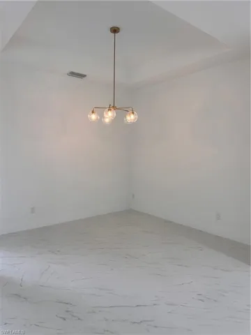 Spare room with a raised ceiling
