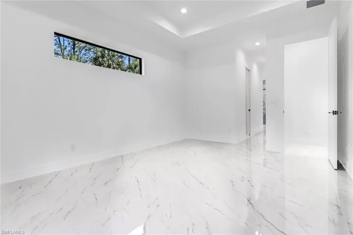 Unfurnished room with light tile patterned floors