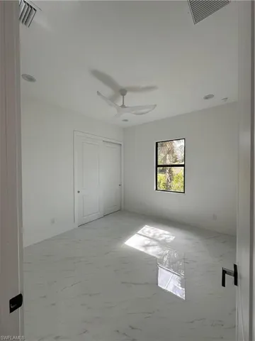 Unfurnished bedroom featuring ceiling fan