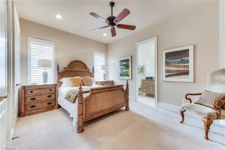 Bedroom featuring recessed lighting, light colored carpet, connected bathroom, ceiling fan, and baseboards