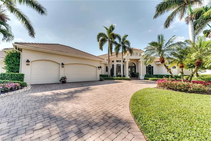 Mediterranean / spanish-style house with decorative driveway, a tile roof, an attached garage, and stucco siding