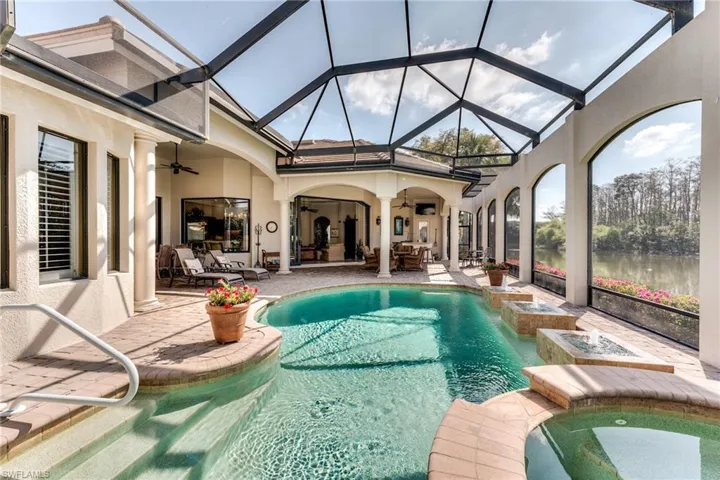 View of pool featuring a lanai, a patio area, a ceiling fan, and outdoor dining space