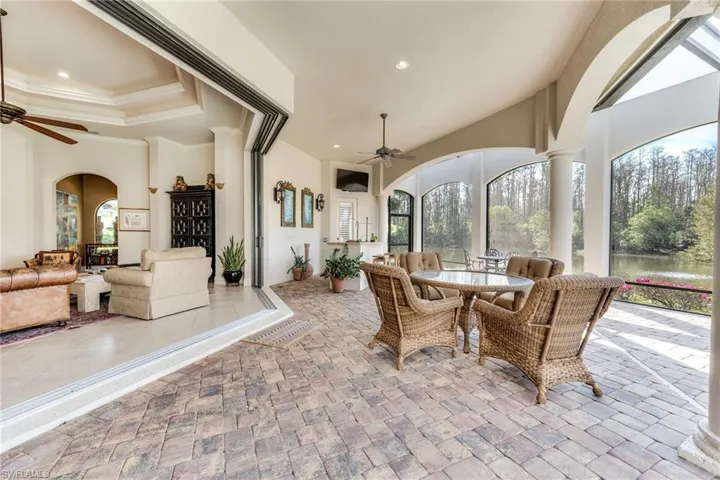 View of patio with outdoor dining area and a ceiling fan