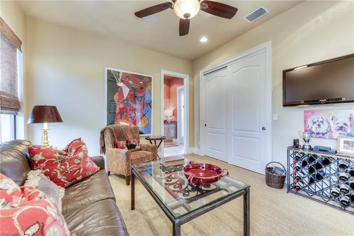 Living room featuring carpet, visible vents, ceiling fan, and recessed lighting