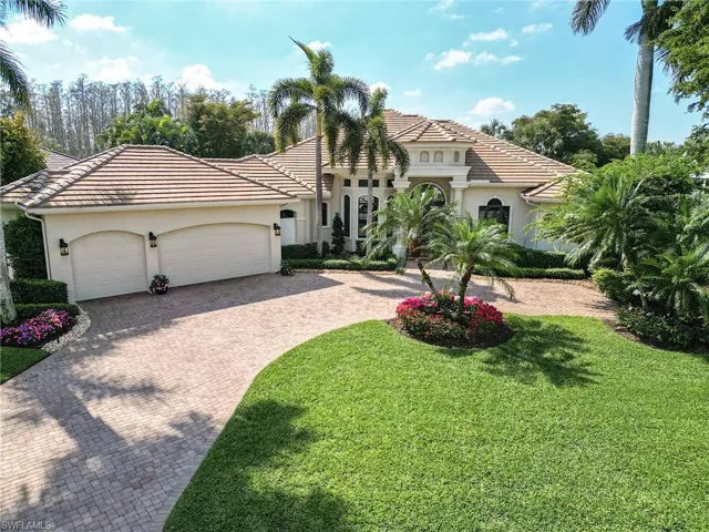 Mediterranean / spanish-style home with decorative driveway, stucco siding, an attached garage, a front yard, and a tiled roof