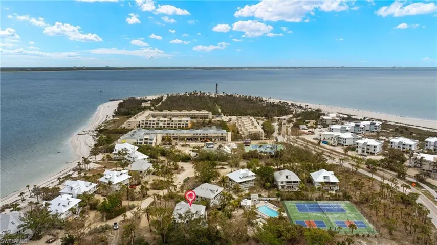 Aerial view featuring a water view and a beach view