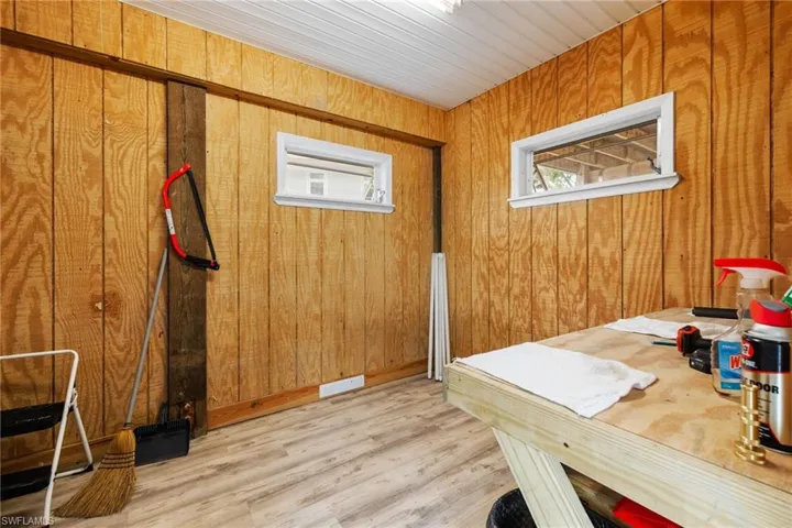 Office featuring wooden walls and light hardwood / wood-style flooring
