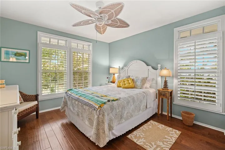 Bedroom featuring ceiling fan and dark hardwood / wood-style flooring